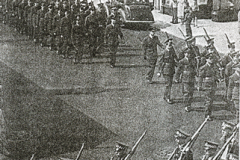 Summer Camp arrival 1950? Marching 
through Porthcawl bayonets fixed. This was 
when the drum major's mace hit an 
overhead cable on its way up but he 
managed to make a complete recovery